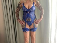 Tattooed blonde Inked MILF uncovers her big tits while removing her lingerie - Photo #1