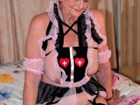 Old blonde woman exposes herself on a bed while wearing cute outfit - Photo #10