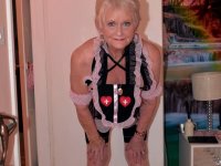 Old blonde woman exposes herself on a bed while wearing cute outfit - Photo #14