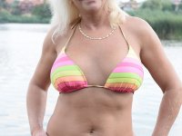 Busty granny named Anett fingering both her holes by the river with passion - Photo #1