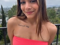 Amateur girl with red fingernails highlights her bald pussy in a red dress - Photo #1