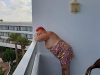 Obese nan with spiky red hair unveils her tits on balcony before posing naked - Photo #2