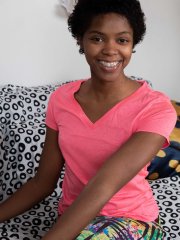 Charming black babe Ashlee L shows her small tits and toys her hairy pussy
