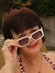 Dark-haired granny Mona strips poolside and shows her hairy holes